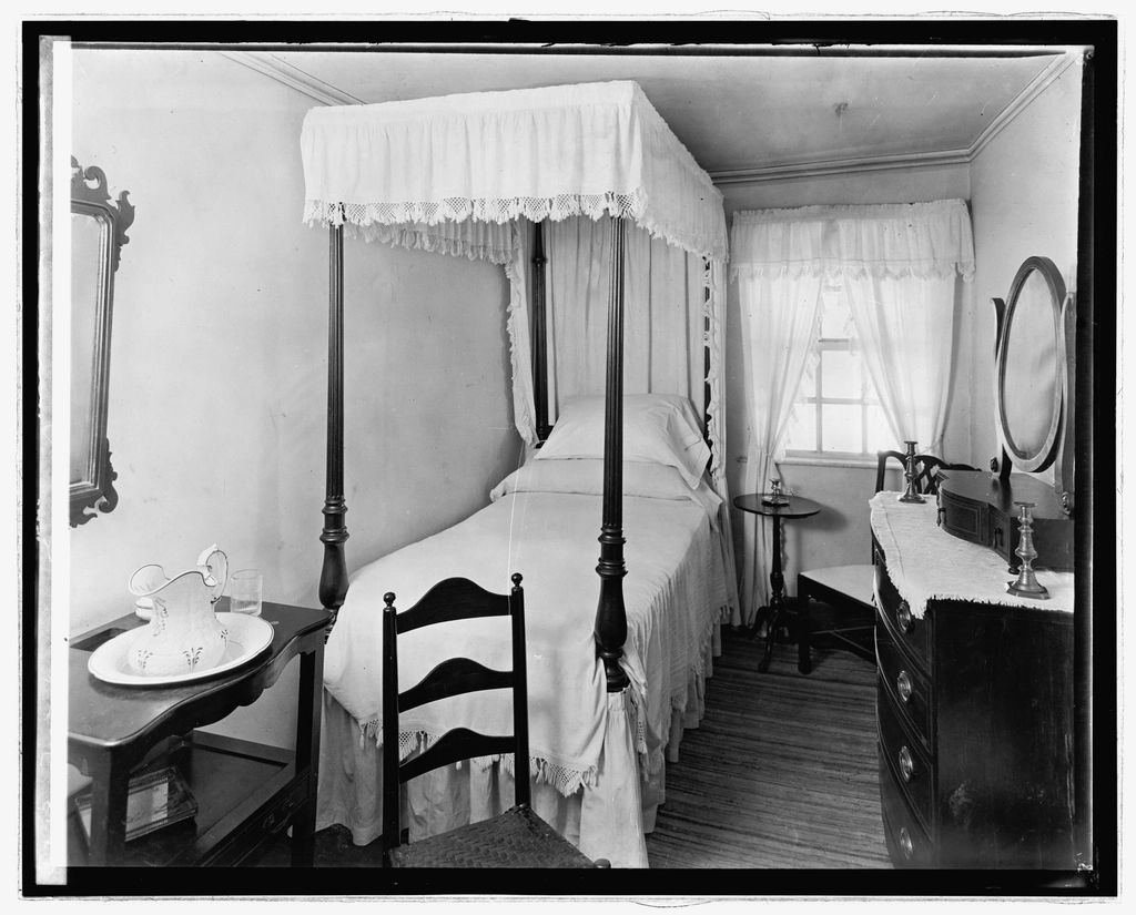 A guest room with two beds and a window